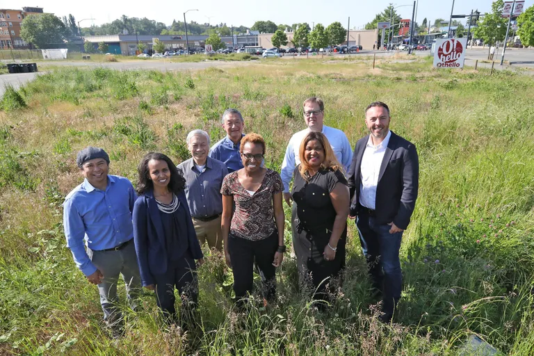 Several of the many individuals involved in Othello Square gather at the project site in Southeast Seattle.