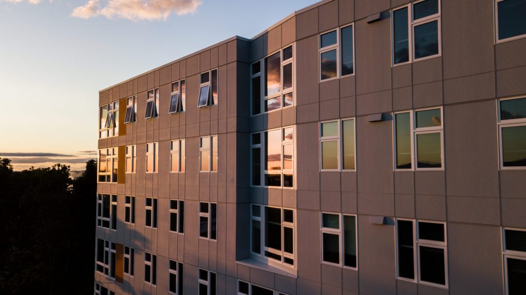 Building exterior with sunset reflected in windows