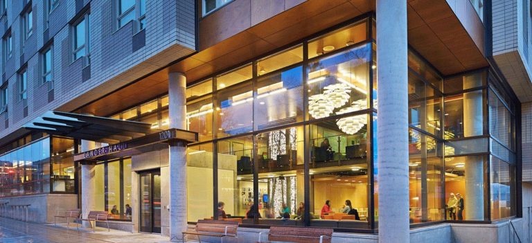 Lander Hall exterior at night looking into lit lobby