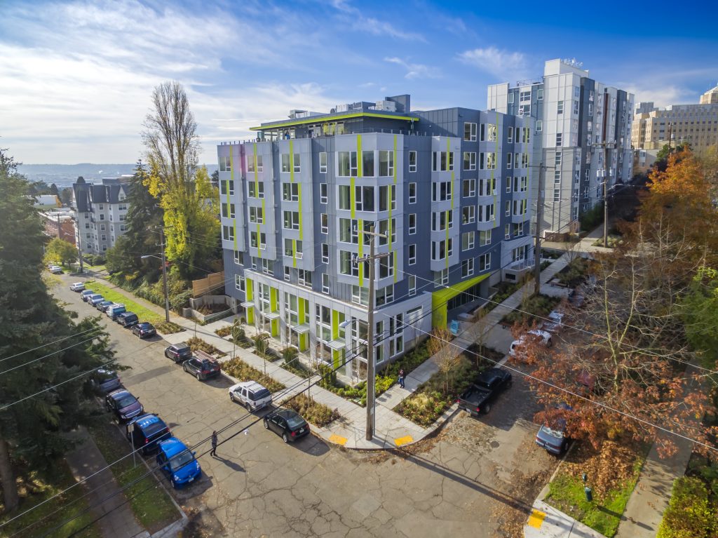 Reverb building exterior, view from corner with neighborhood in the background