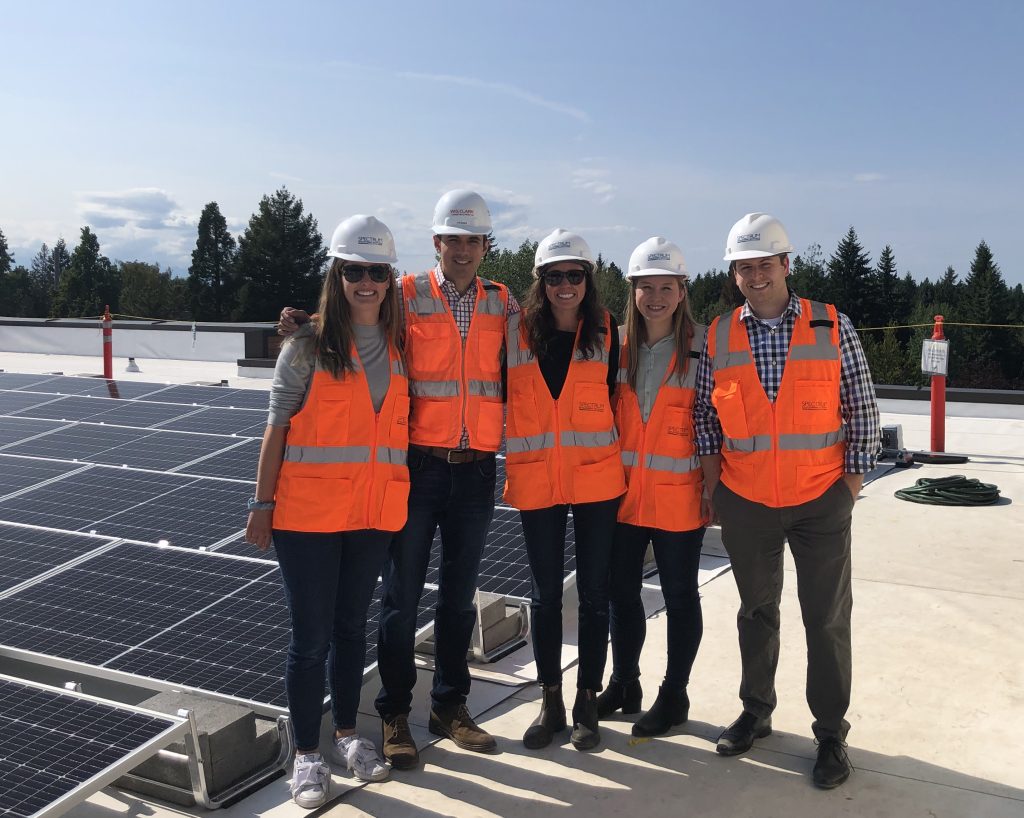 Team photo in safety equipment outside on rooftop