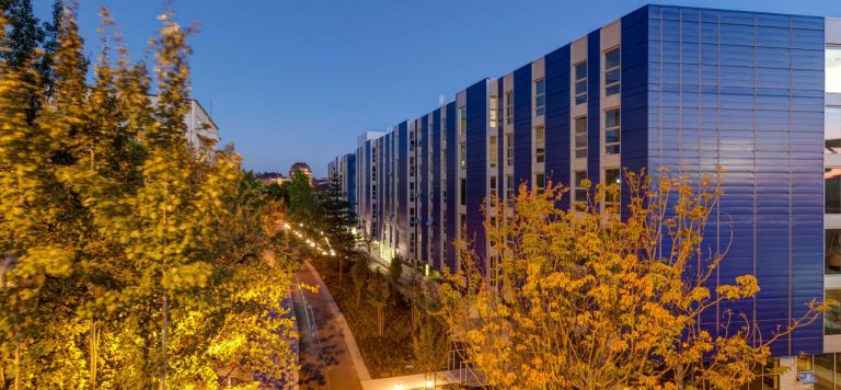 Nighttime shot of Mercer Court exterior with trees in foreground